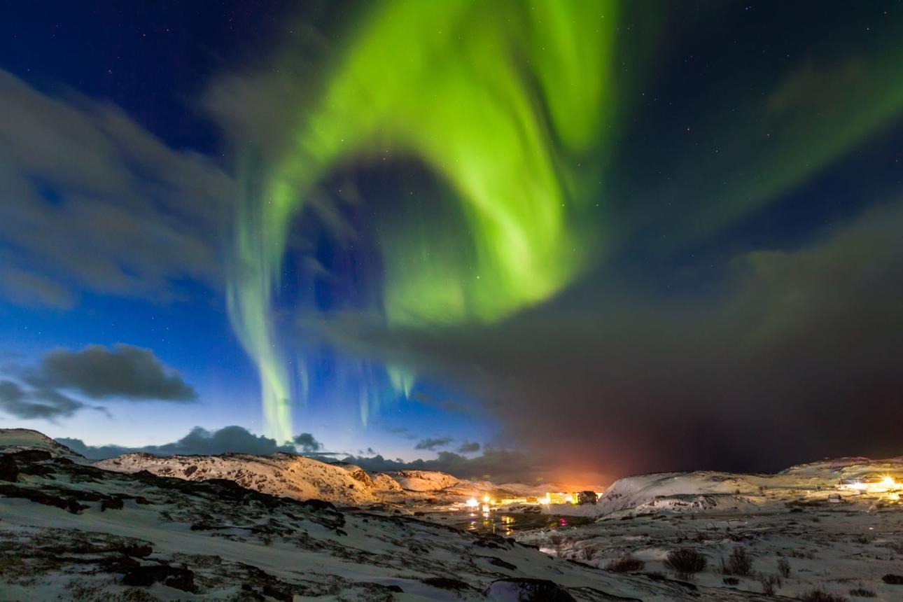 Northern lights over the snow-capped mountains